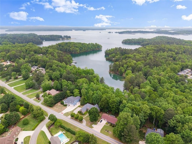 drone / aerial view featuring a water view and a wooded view