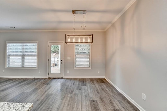 unfurnished dining area with hardwood / wood-style flooring and ornamental molding