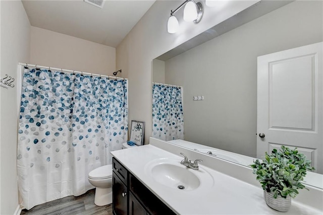 bathroom with vanity, curtained shower, wood-type flooring, and toilet