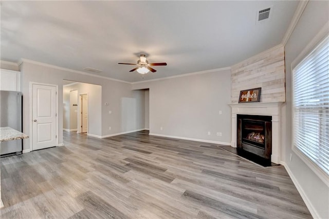 unfurnished living room with crown molding, ceiling fan, and hardwood / wood-style floors