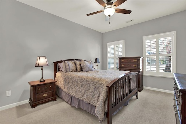 bedroom with ceiling fan and light colored carpet