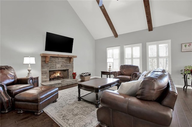 living room featuring a fireplace, dark hardwood / wood-style floors, high vaulted ceiling, and a healthy amount of sunlight