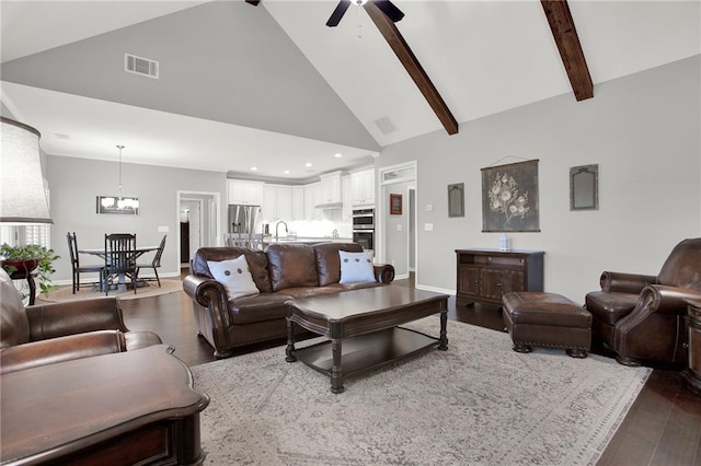 living room with ceiling fan, sink, beamed ceiling, high vaulted ceiling, and hardwood / wood-style floors