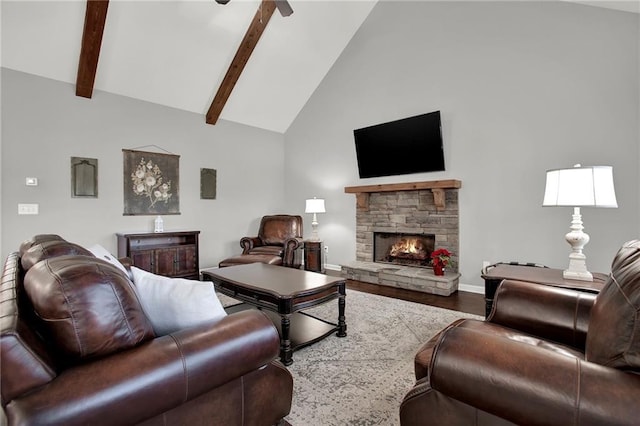 living room with ceiling fan, beam ceiling, hardwood / wood-style flooring, high vaulted ceiling, and a fireplace