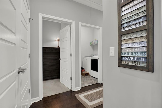 corridor featuring dark hardwood / wood-style floors, washer / dryer, and ornamental molding