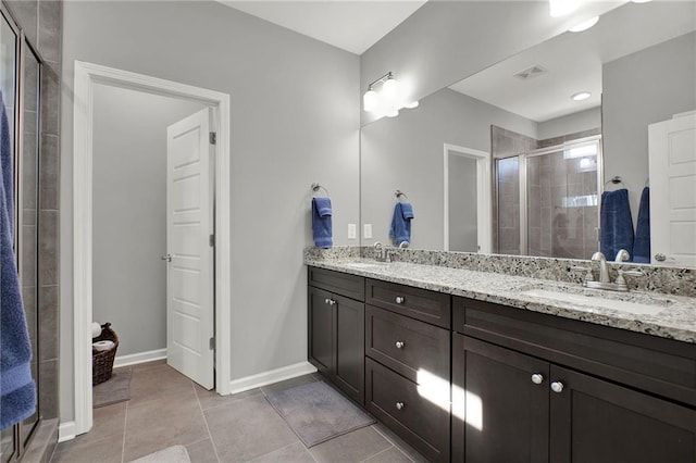 bathroom with tile patterned flooring, vanity, and a shower with shower door