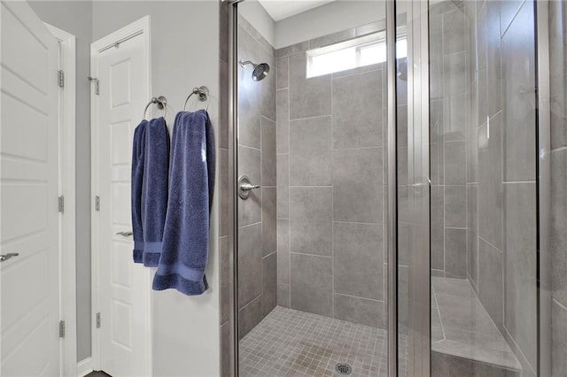 bathroom with a shower with door