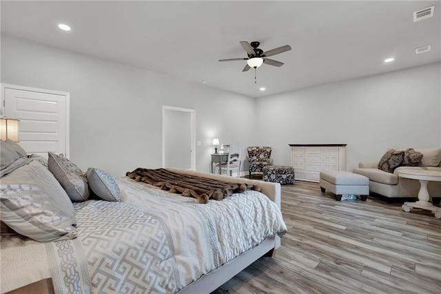 bedroom with ceiling fan and light hardwood / wood-style floors