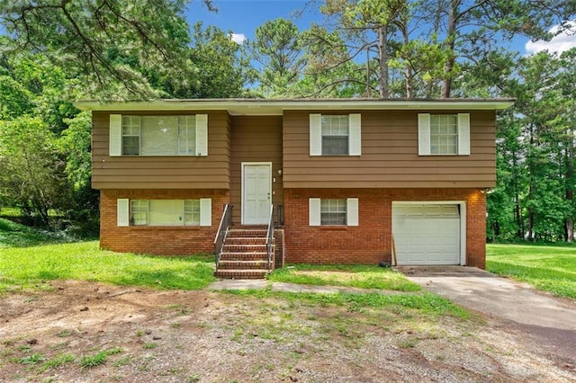 1991 Flat Shoals Rd, Riverdale, GA 30296 - raised ranch with an attached garage, driveway, brick siding, and a front yard