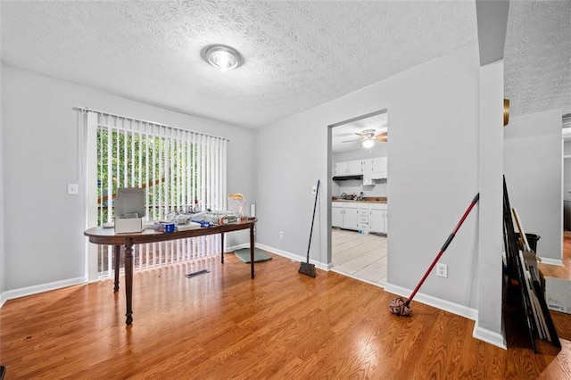 1991 Flat Shoals Rd, Riverdale, GA 30296 - office space featuring a textured ceiling, wood finished floors, and a ceiling fan