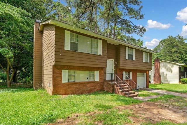1991 Flat Shoals Rd, Riverdale, GA 30296 - bi-level home with brick siding, a chimney, an attached garage, a front yard, and driveway