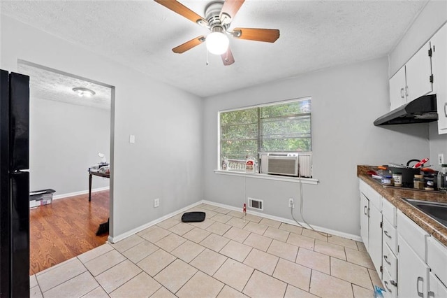 1991 Flat Shoals Rd, Riverdale, GA 30296 - laundry area featuring a textured ceiling, ceiling fan, light tile patterned flooring, and cooling unit