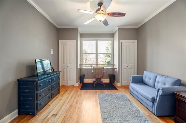 living area with crown molding, light hardwood / wood-style floors, and ceiling fan