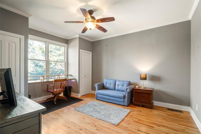 living area with ornamental molding, ceiling fan, and light hardwood / wood-style floors