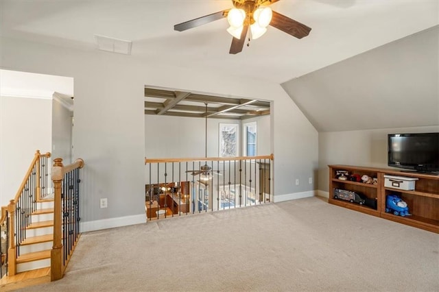 bonus room with beamed ceiling and carpet floors