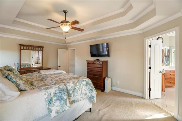 bedroom with ornamental molding, light colored carpet, ceiling fan, and a tray ceiling