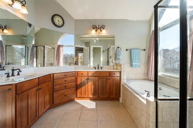 bathroom featuring tile patterned flooring, vanity, vaulted ceiling, and independent shower and bath