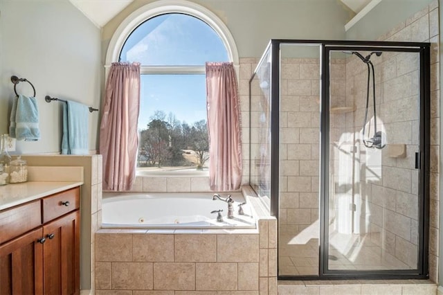 bathroom with vanity, separate shower and tub, and vaulted ceiling