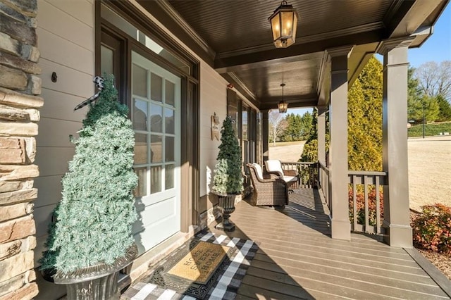 wooden terrace featuring covered porch