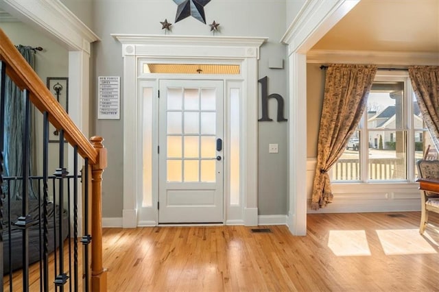 foyer entrance with light hardwood / wood-style floors