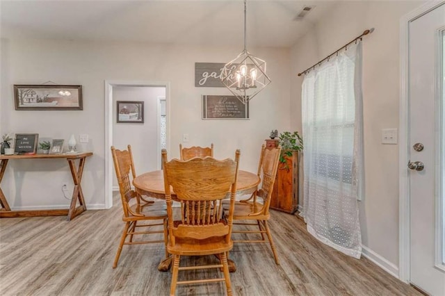 22 Gowen Dr, Rome, GA 30165 - dining space featuring wood finished floors, a chandelier, and baseboards