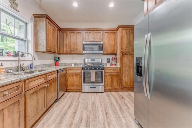 22 Gowen Dr, Rome, GA 30165 - kitchen featuring appliances with stainless steel finishes, a sink, light wood-style flooring, light stone countertops, and recessed lighting