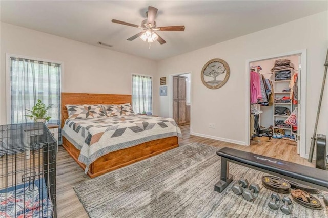 22 Gowen Dr, Rome, GA 30165 - bedroom with wood finished floors, a spacious closet, baseboards, a closet, and a ceiling fan