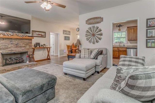 22 Gowen Dr, Rome, GA 30165 - living room with ceiling fan, wood finished floors, baseboards, and a stone fireplace