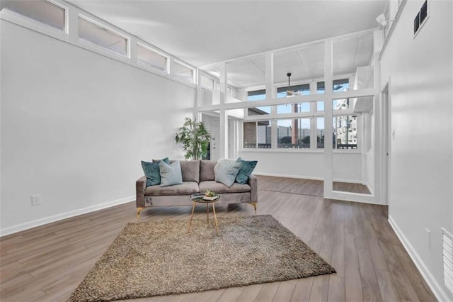 living room with ceiling fan and wood-type flooring