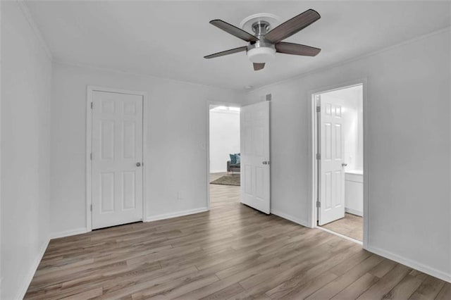 unfurnished bedroom with ceiling fan, a closet, ensuite bathroom, and light hardwood / wood-style floors