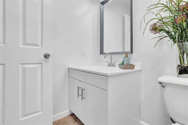 bathroom with tile patterned flooring, vanity, and toilet