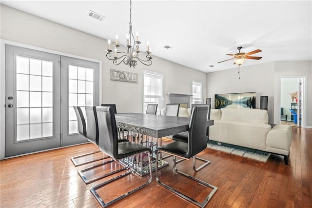 2625 Blackstock Dr, Cumming, GA 30041 - dining area featuring wood-type flooring, visible vents, and ceiling fan with notable chandelier