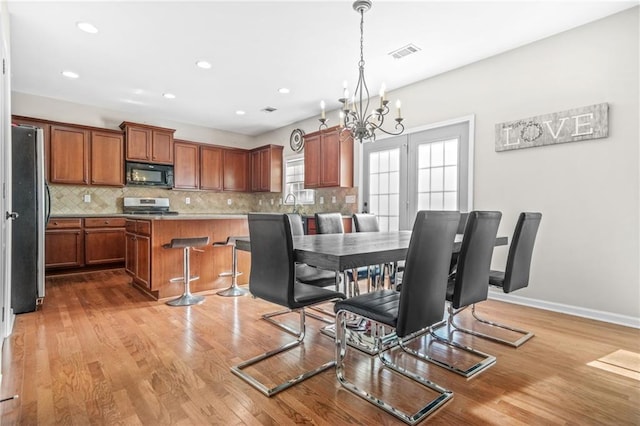 2625 Blackstock Dr, Cumming, GA 30041 - dining room with a chandelier, visible vents, light wood finished floors, and recessed lighting