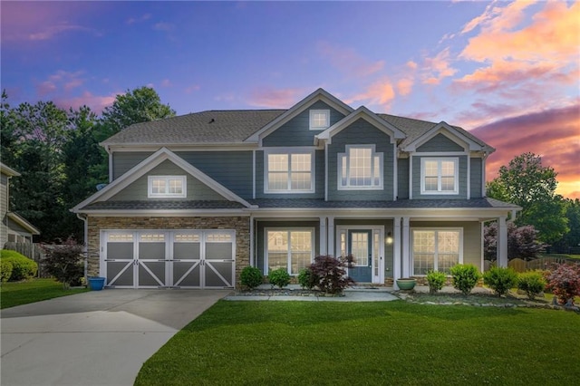 2625 Blackstock Dr, Cumming, GA 30041 - craftsman-style home with concrete driveway, a lawn, stone siding, covered porch, and an attached garage