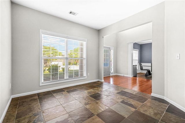 2625 Blackstock Dr, Cumming, GA 30041 - unfurnished room with plenty of natural light, stone tile floors, baseboards, and visible vents