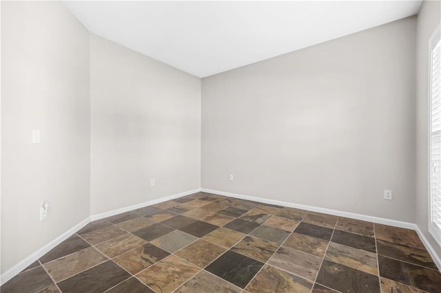 2625 Blackstock Dr, Cumming, GA 30041 - spare room featuring stone tile flooring, plenty of natural light, and baseboards