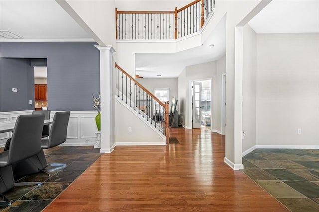 2625 Blackstock Dr, Cumming, GA 30041 - entryway with a towering ceiling, ornate columns, wood finished floors, baseboards, and stairs