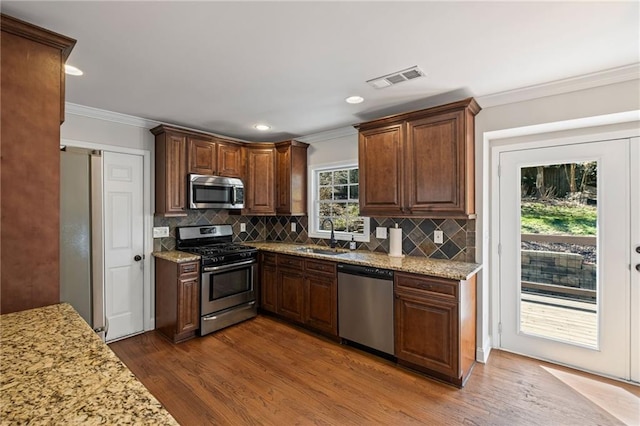260 Mansell Cir, Roswell, GA 30075 - kitchen featuring dark wood-style floors, visible vents, ornamental molding, a sink, and appliances with stainless steel finishes