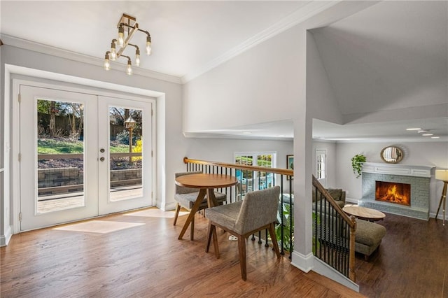 260 Mansell Cir, Roswell, GA 30075 - dining room featuring wood finished floors, baseboards, a warm lit fireplace, ornamental molding, and french doors
