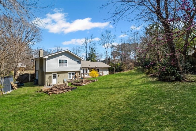 260 Mansell Cir, Roswell, GA 30075 - back of house featuring a yard, fence, and a chimney