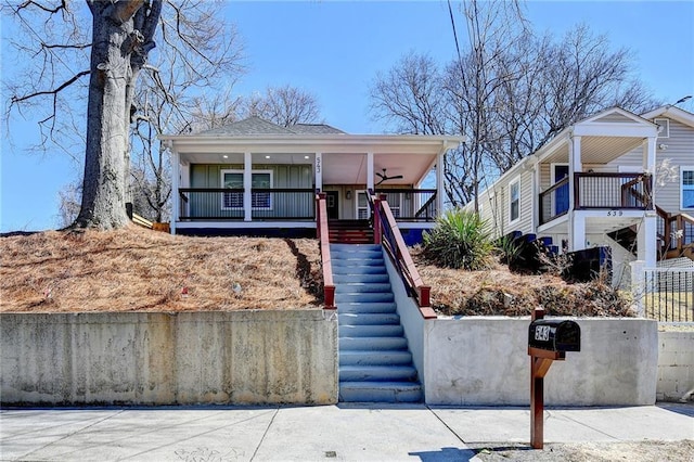 543 Paines Ave NW, Atlanta, GA 30318 - view of front of house with a shingled roof, covered porch, fence, and stairs