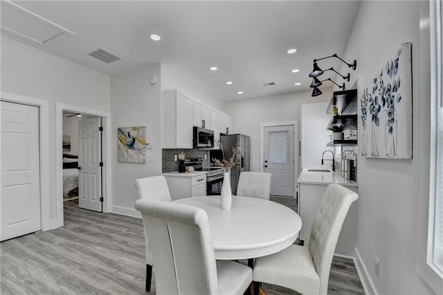 543 Paines Ave NW, Atlanta, GA 30318 - dining area with baseboards, recessed lighting, visible vents, and light wood-style floors