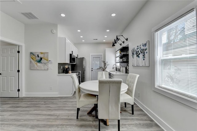543 Paines Ave NW, Atlanta, GA 30318 - dining room with recessed lighting, visible vents, light wood-style flooring, and baseboards