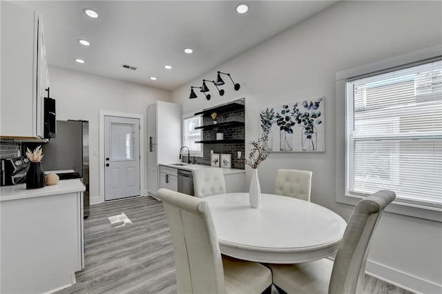 543 Paines Ave NW, Atlanta, GA 30318 - dining space featuring baseboards, visible vents, light wood-type flooring, a fireplace, and recessed lighting