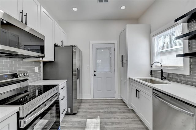 543 Paines Ave NW, Atlanta, GA 30318 - kitchen with a sink, stainless steel appliances, light countertops, and white cabinetry