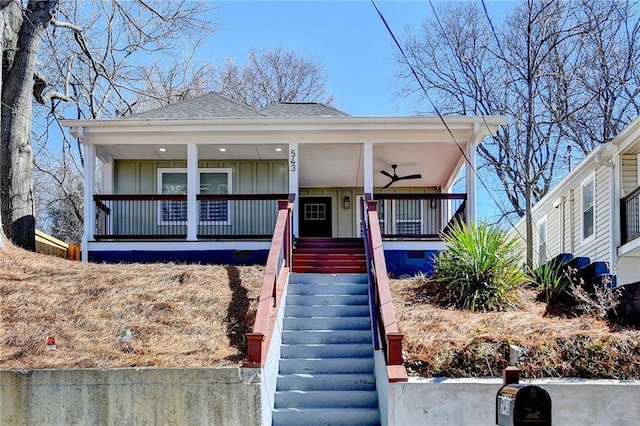 view of front of property with roof with shingles, covered porch, stairway, board and batten siding, and a ceiling fan