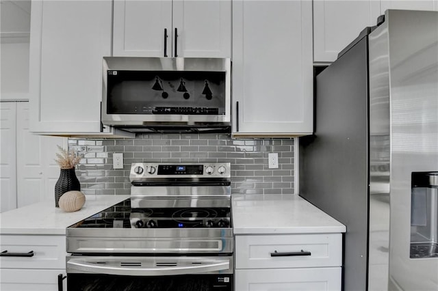 543 Paines Ave NW, Atlanta, GA 30318 - kitchen with white cabinetry, appliances with stainless steel finishes, and tasteful backsplash