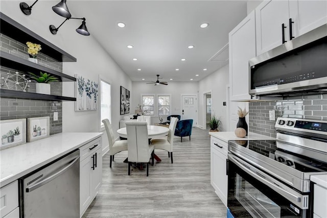 543 Paines Ave NW, Atlanta, GA 30318 - kitchen featuring recessed lighting, white cabinets, light countertops, appliances with stainless steel finishes, and open shelves