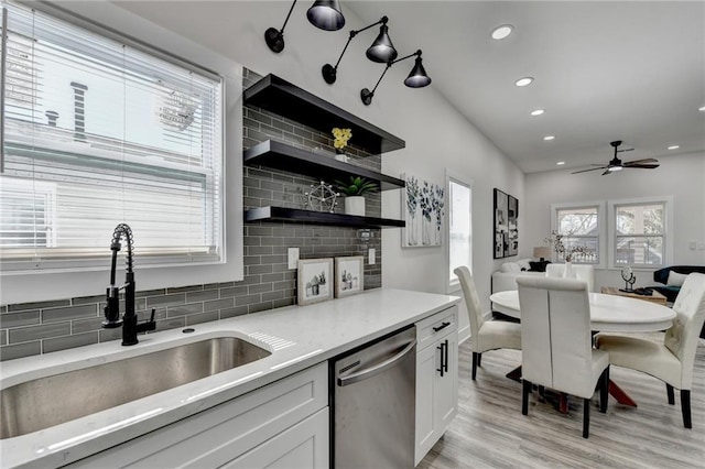 543 Paines Ave NW, Atlanta, GA 30318 - kitchen featuring a sink, white cabinetry, light countertops, stainless steel dishwasher, and backsplash