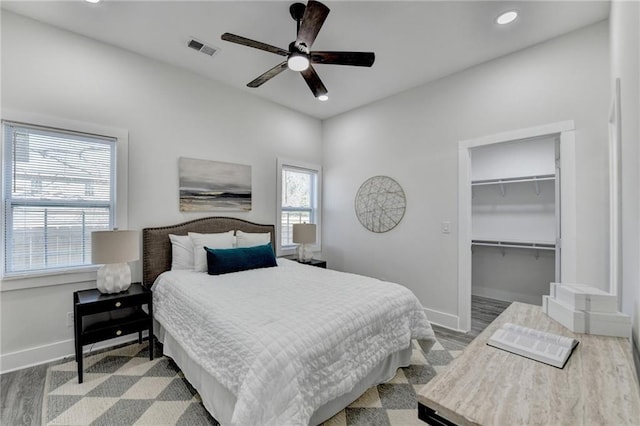 543 Paines Ave NW, Atlanta, GA 30318 - bedroom featuring visible vents, a spacious closet, baseboards, and wood finished floors